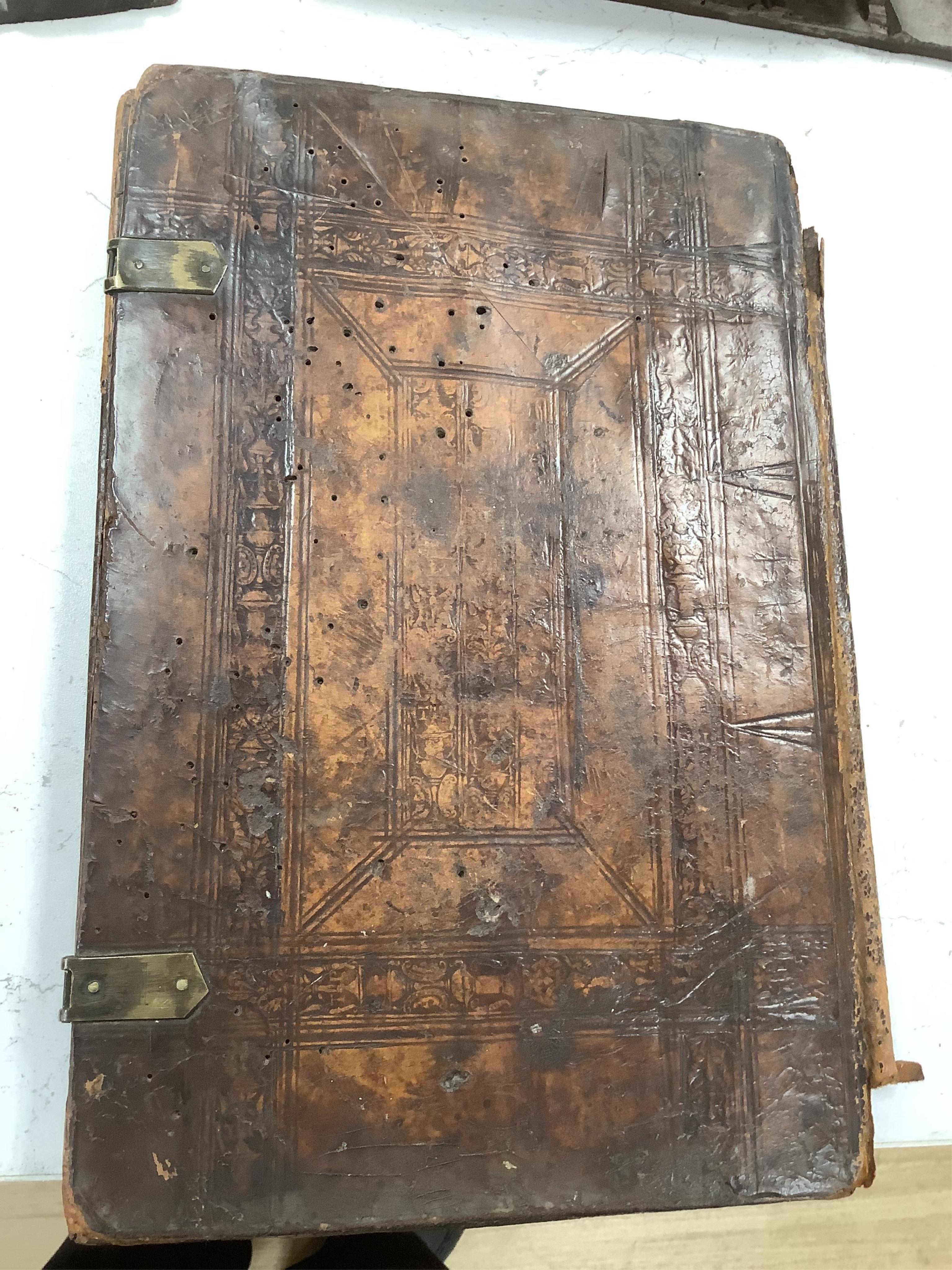 A 19th century leather binding for a book, 35cm high x 33.5cm wide, two carved gothic panels and a carved figure